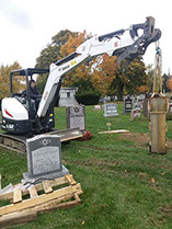 Karen Haskell herself driving the bobcat and setting stones in the cemetery