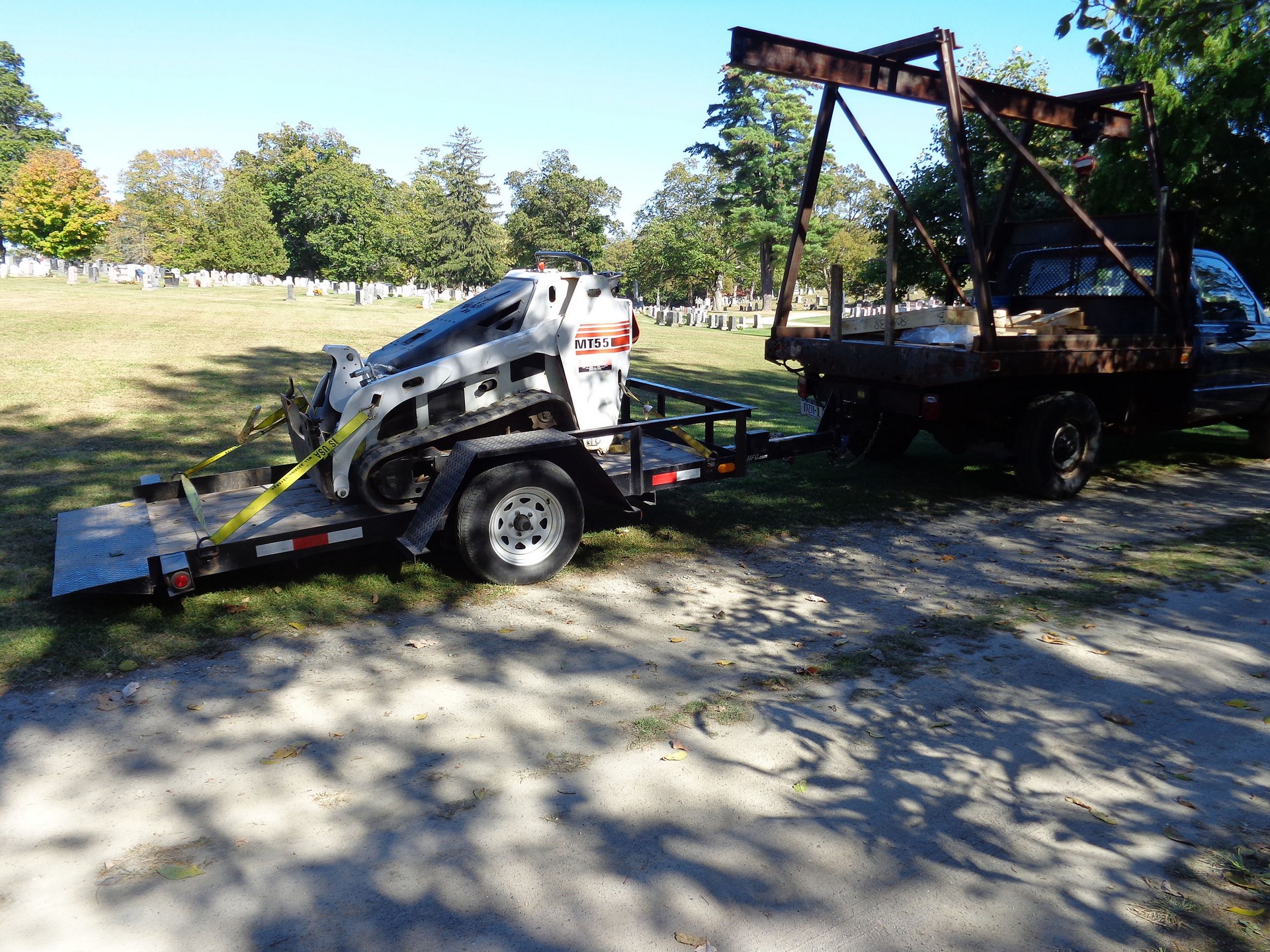 A bobcat used in setting stones in the cemetery